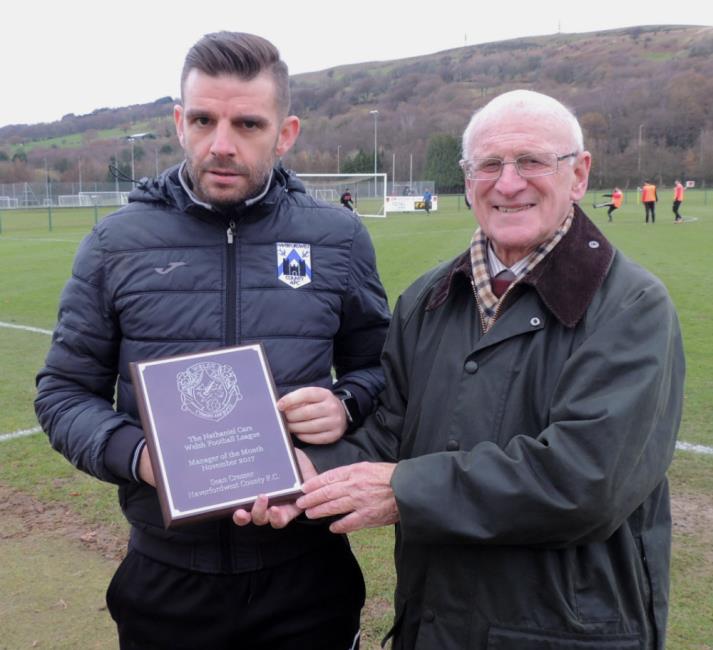Sean Cresser receiving his Manager of the Month award from Ken Tucker